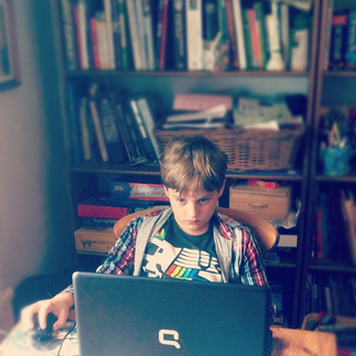teen on computer in home office
