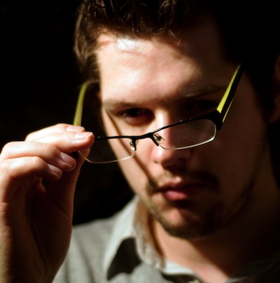 man looking at glasses