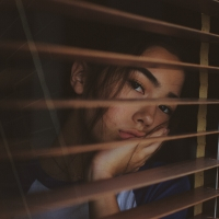 sad woman looking out window