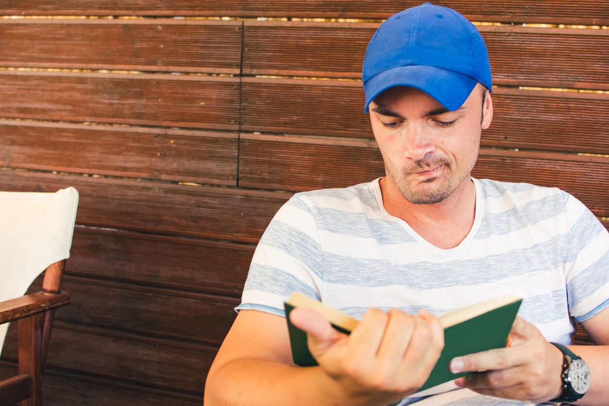 A dangerous-looking man reading a book.