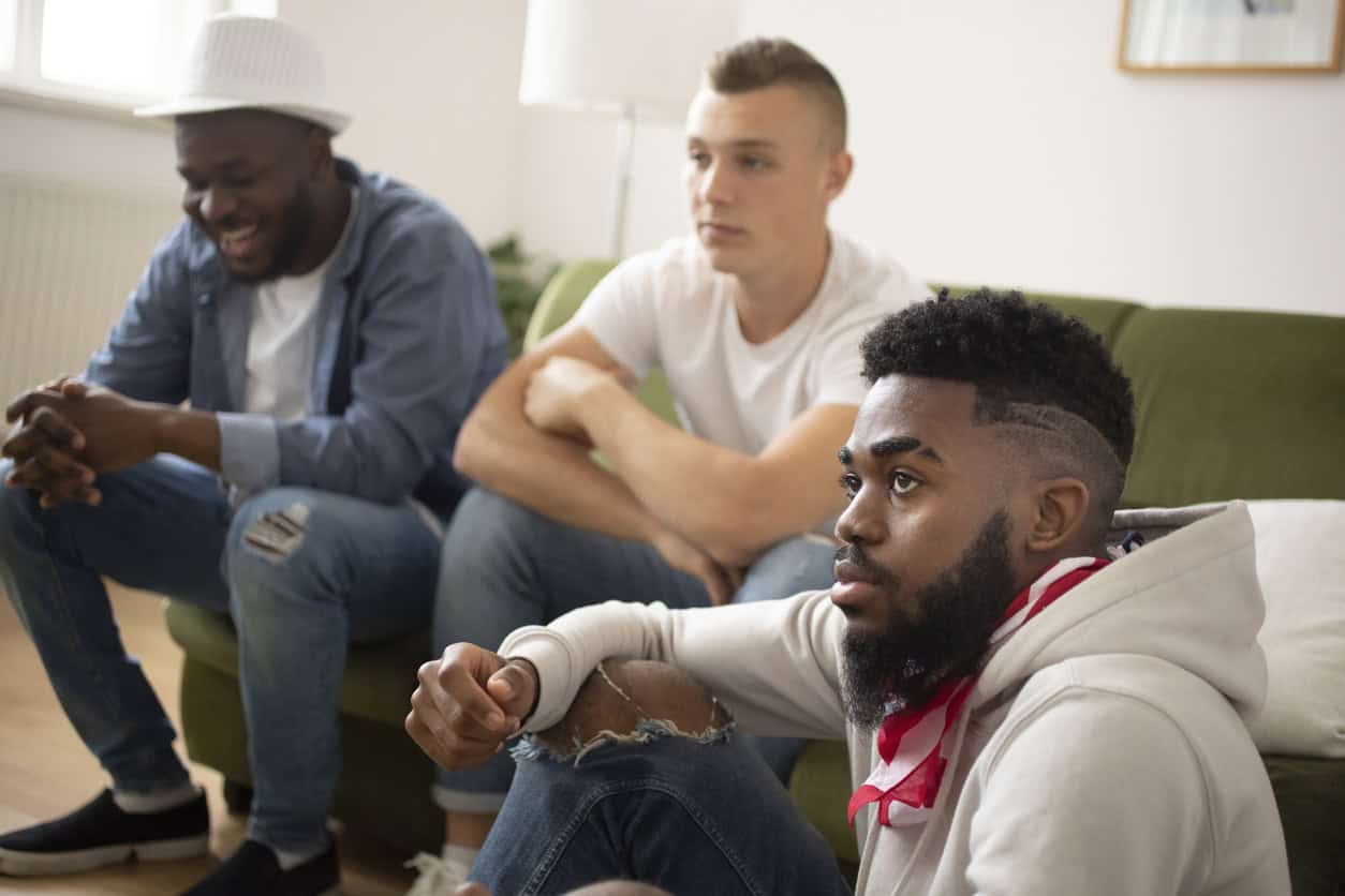 Three men at a 12-step meeting.