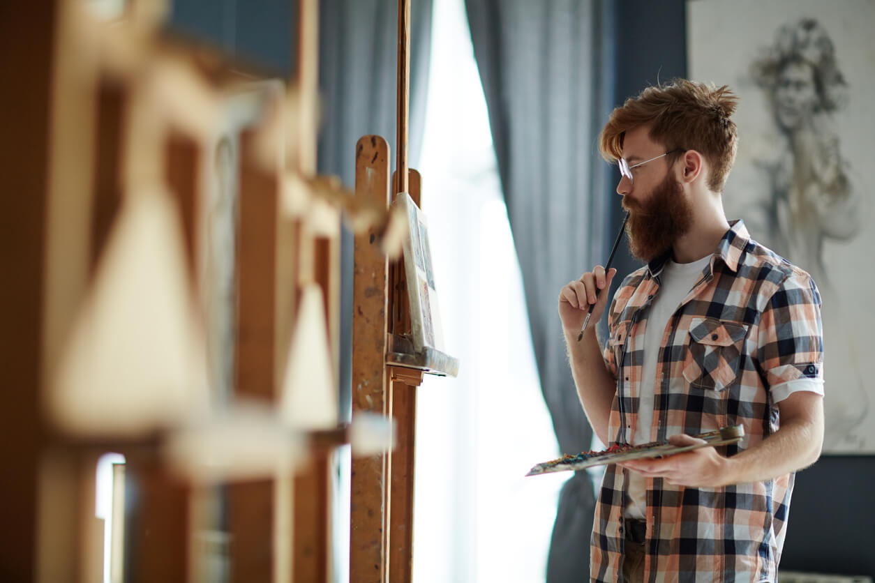 A man painting a portrait.