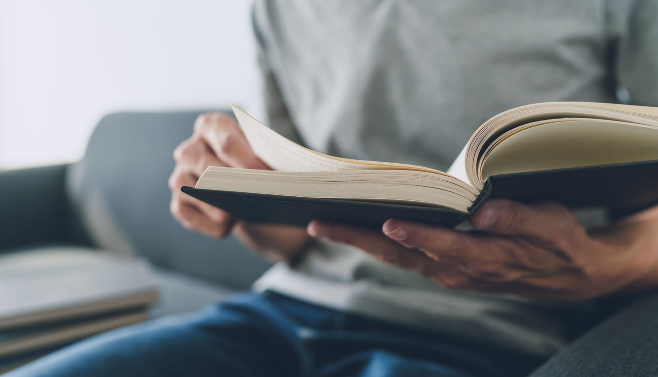 Hands of man reading Bible.