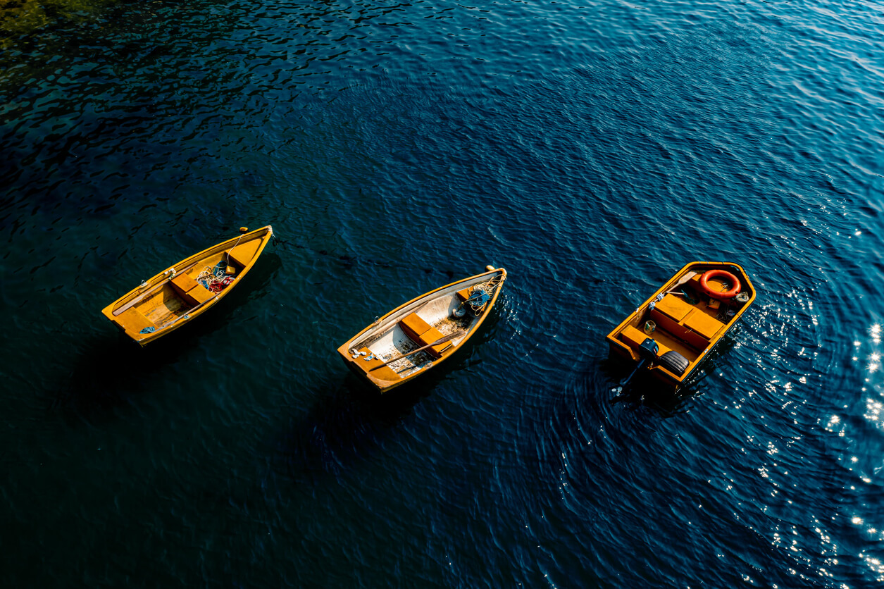 3 boats floating in the water, symbolizing boys adrift.