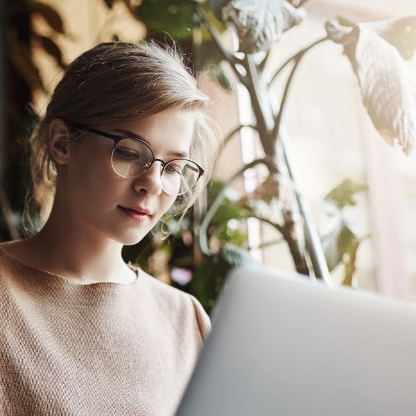 young woman looking at computer alone