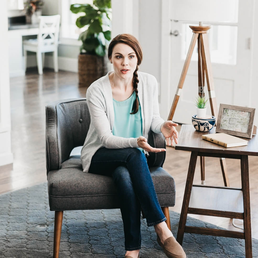 woman sitting on armchair and talking