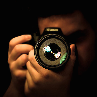 man looking through camera