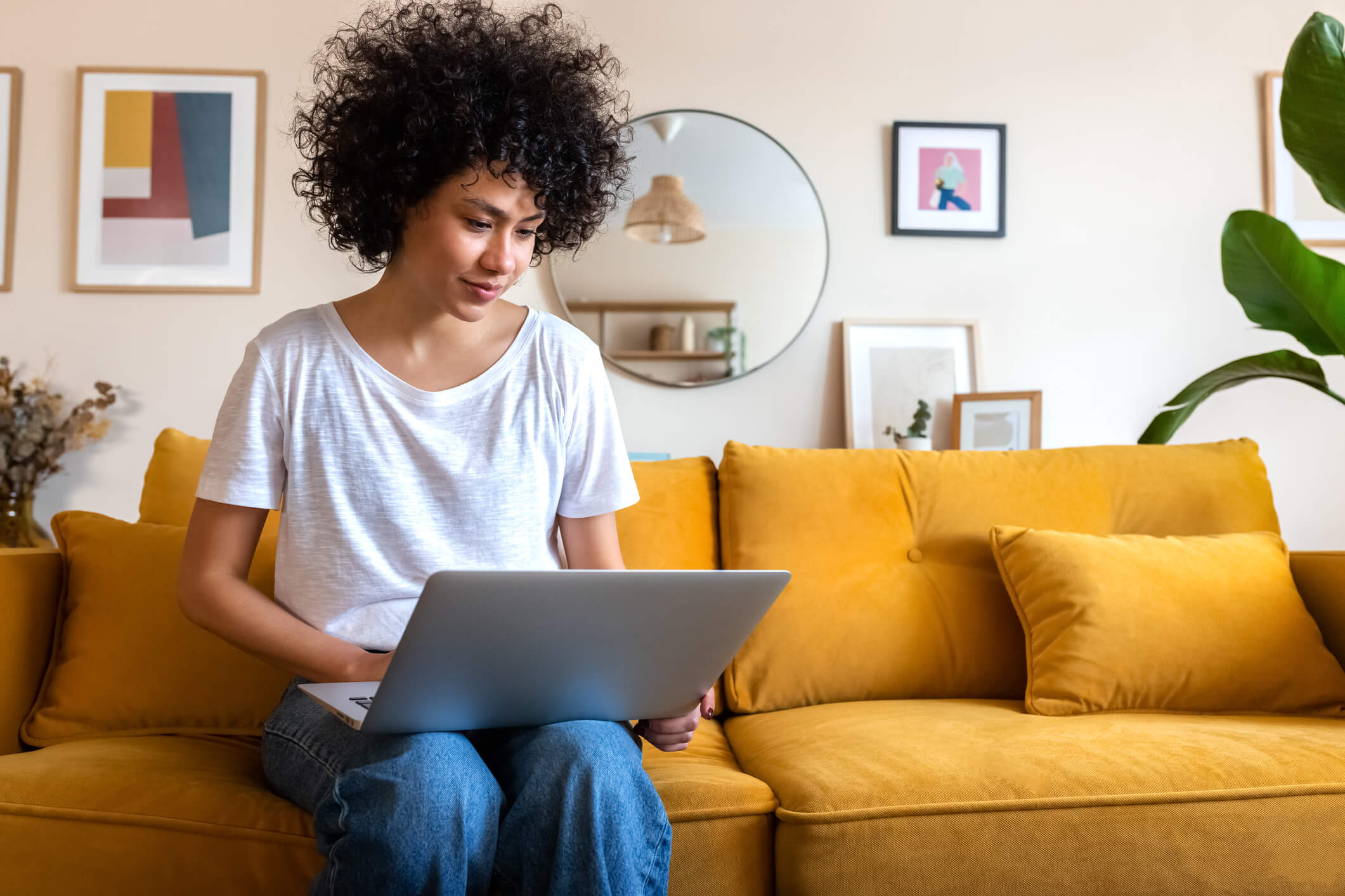 Happy Mixed Race Couple Relax On Couch In Living Room Watch Movie