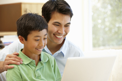 father and son on laptop