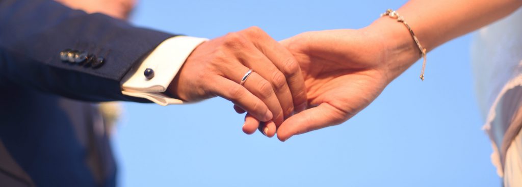 bride and groom holding hands