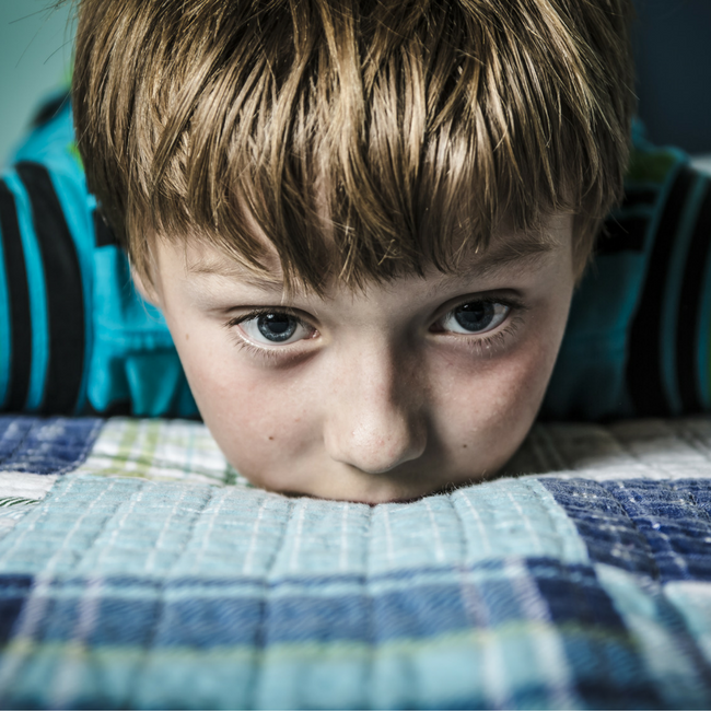 young boy on bed