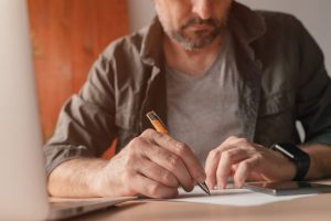 Man writing a list of reasons to avoid porn.