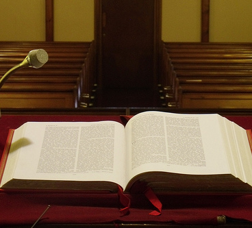 bible open in front of church pews