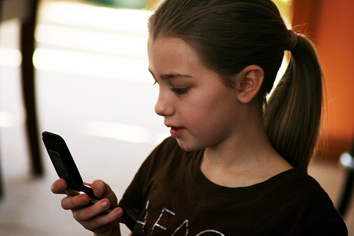girl looking at mobile device