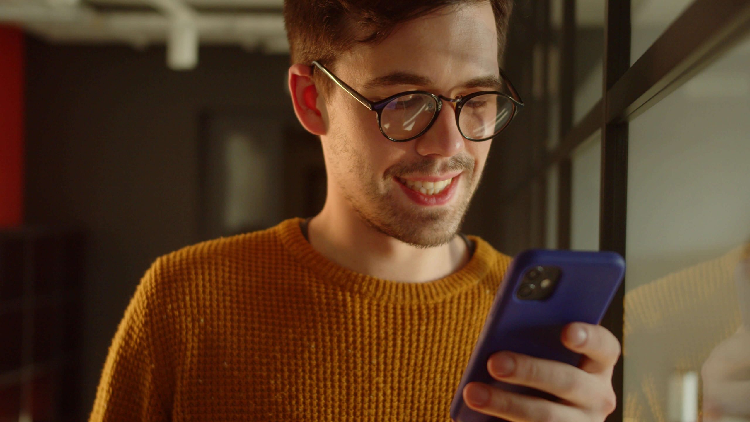 A young man looking at his phone.