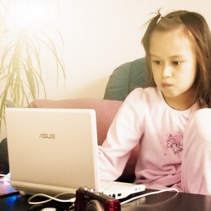 young girl on computer alone