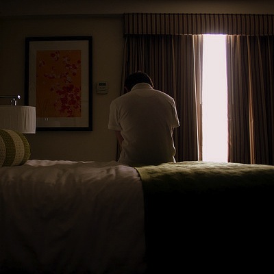 man sitting on hotel bed