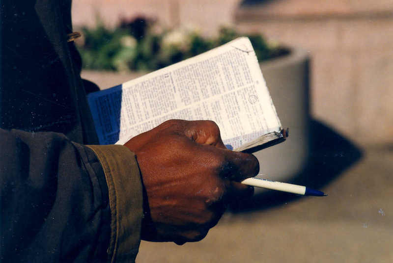 man walking with bible