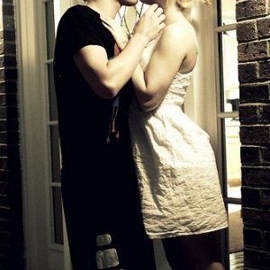 couple kissing by front door
