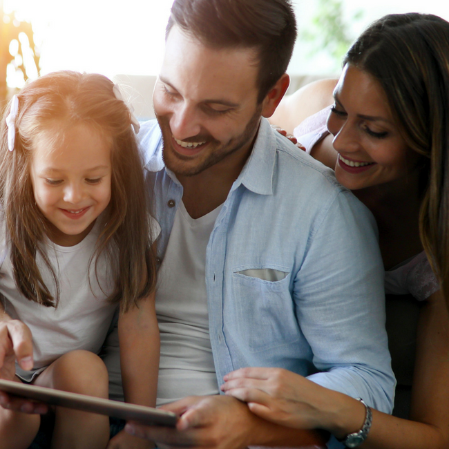 young family on tablet together