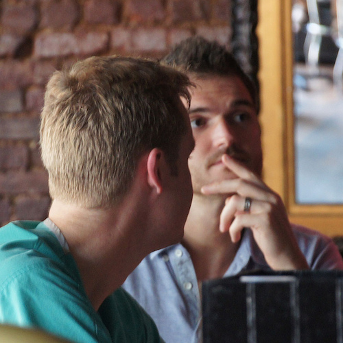 two guys talking at table