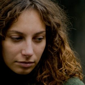 curly haired woman looking down