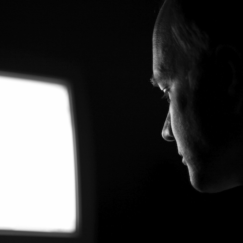 man on computer in dark