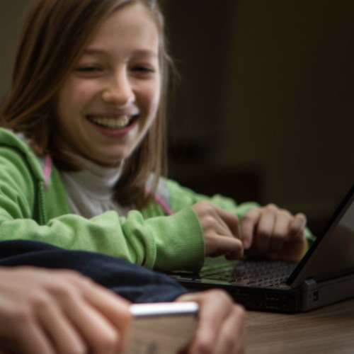 girl laughing on computer