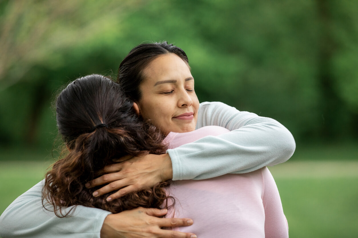 A woman giving an encouraging hug to a sexually broken younger woman.