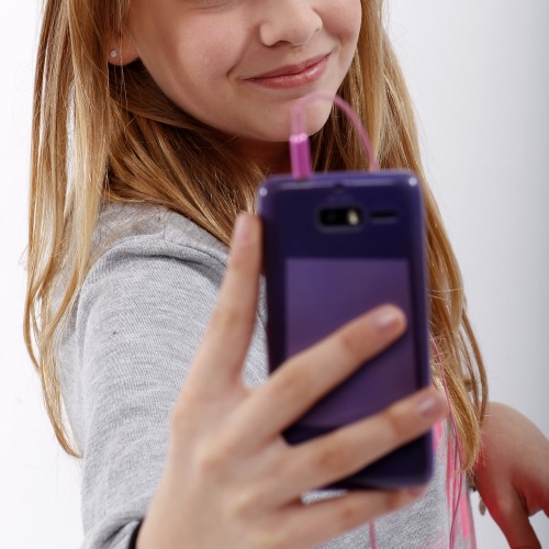 girl with headphones smiling at phone