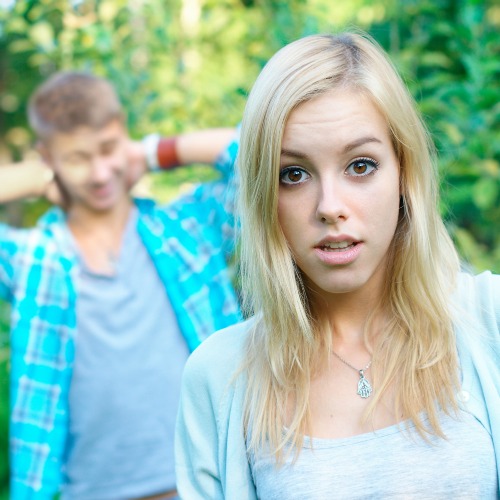 surprised girl with boyfriend behind her