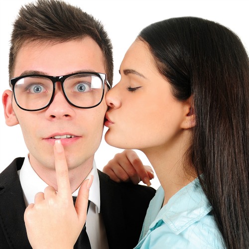woman kissing surprised man on cheek