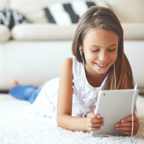 young girl smiling on tablet