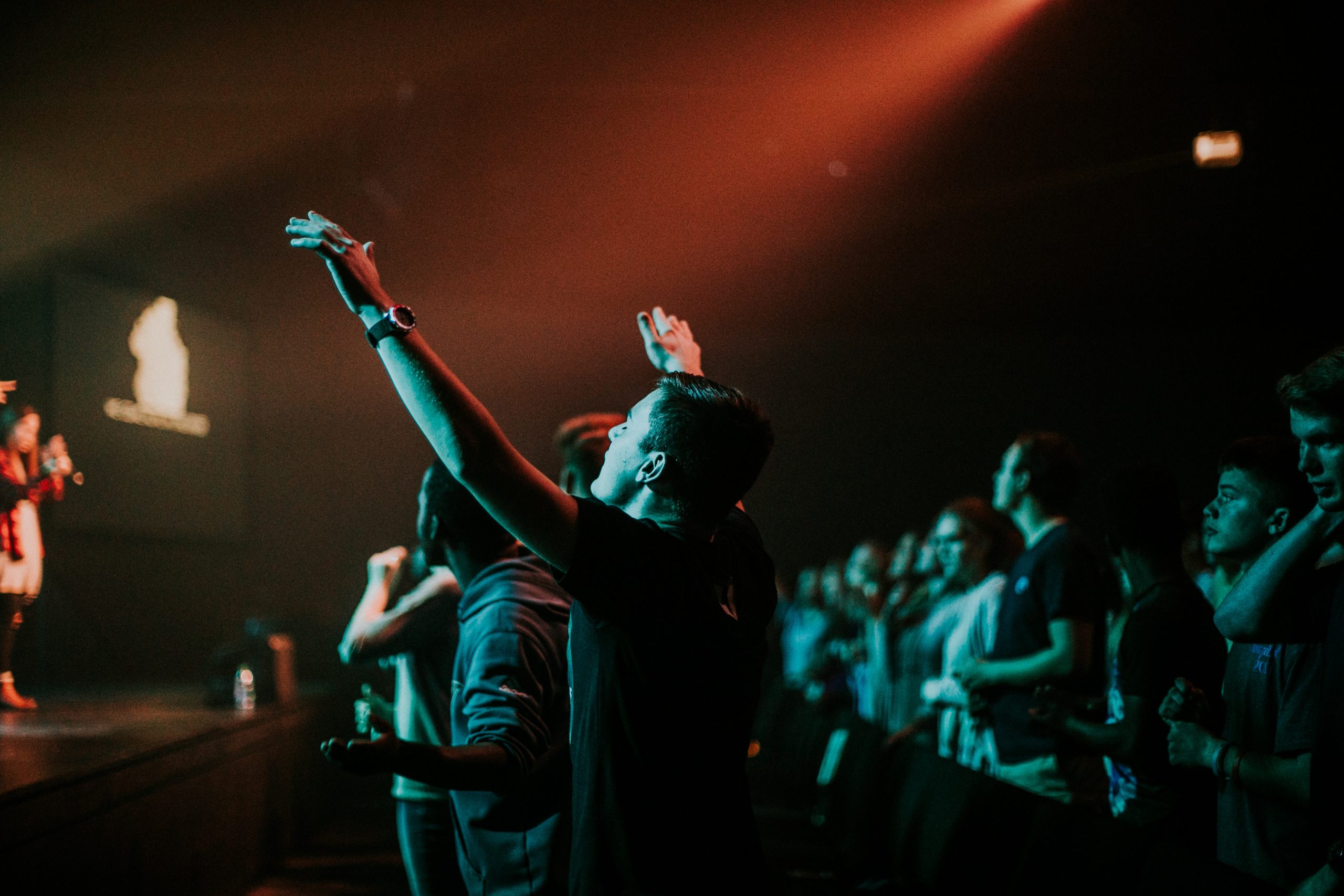 man worshiping with raised hands