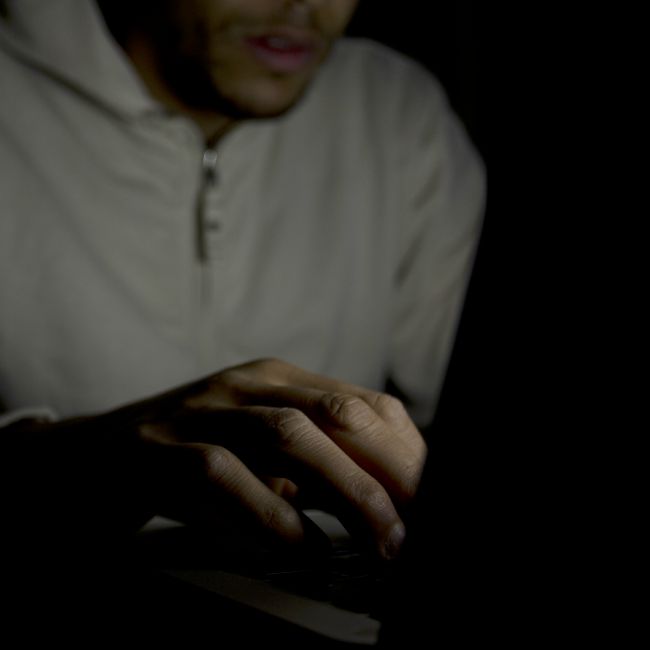 man on computer at night