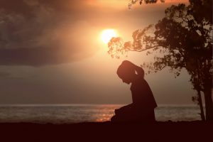 A young woman praying to be free from porn.