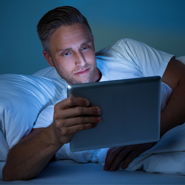 MAN ON COMPUTER AT NIGHT