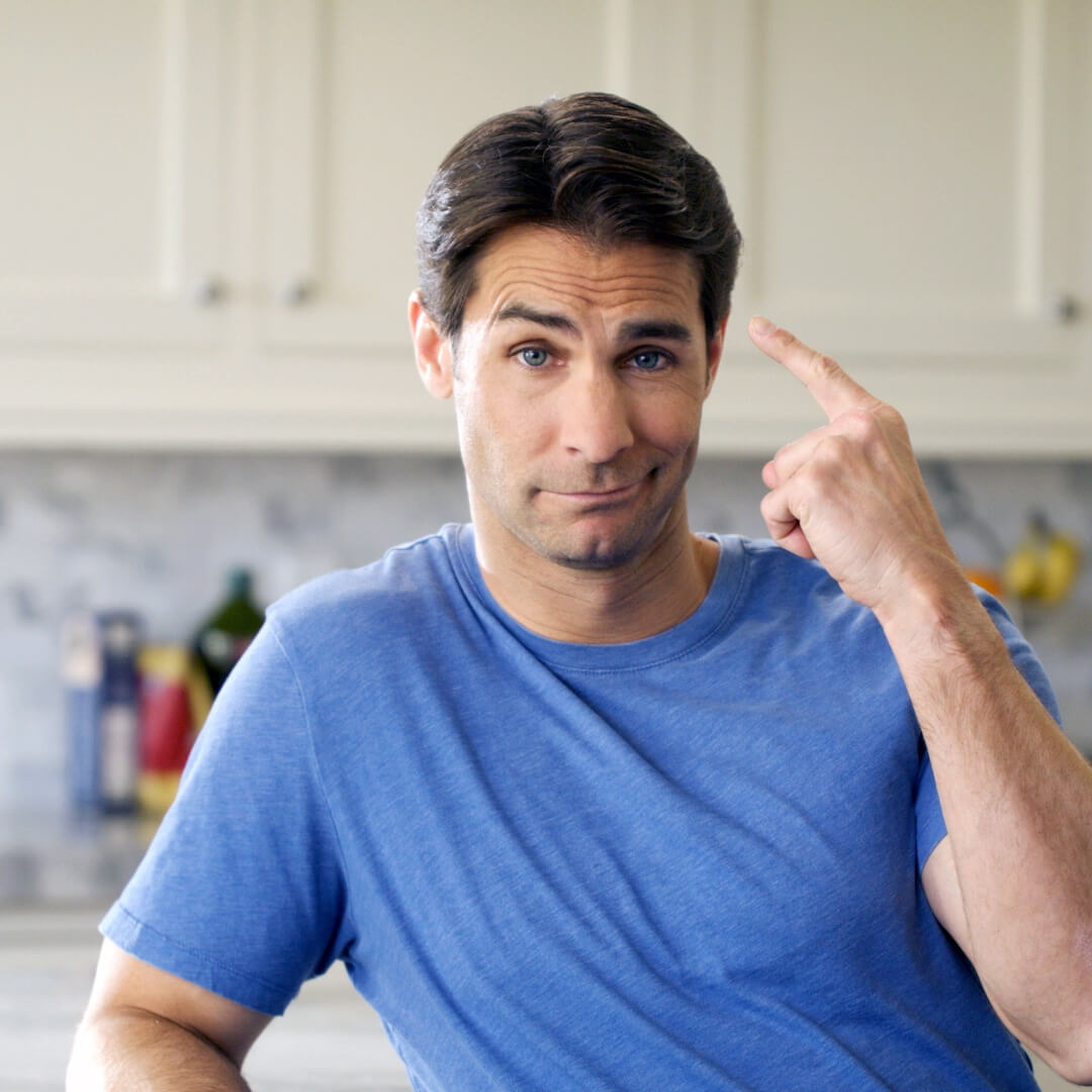 man pointing at brain