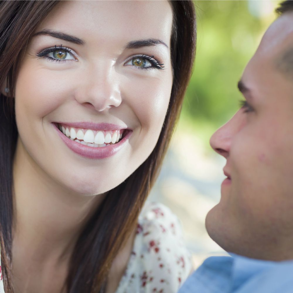 boyfriend staring at smiling girlfriend