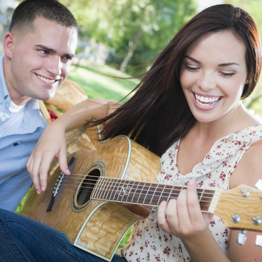 girl playing guitar for boyfriend