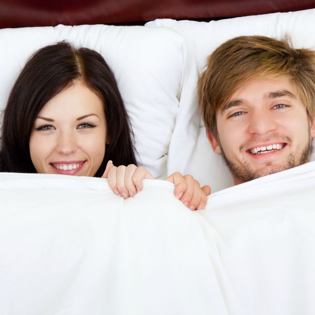 couple smiling in bed