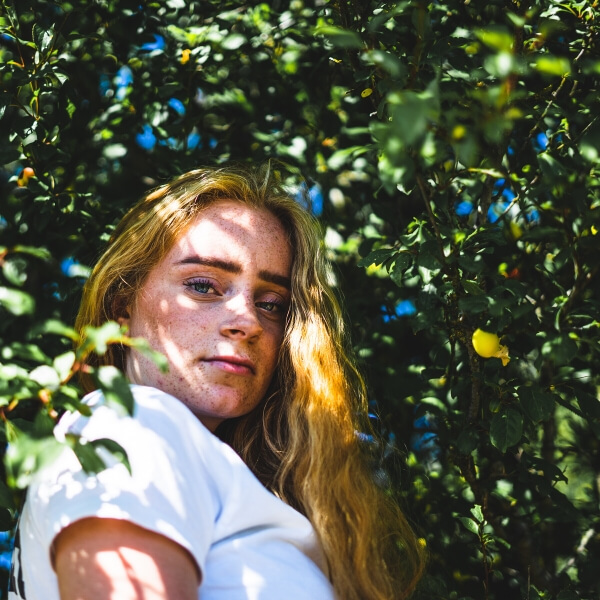 girl hiding in tree