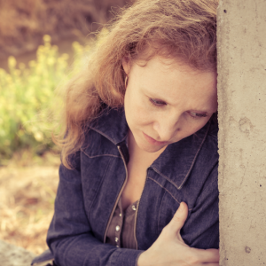 sad woman sitting outside