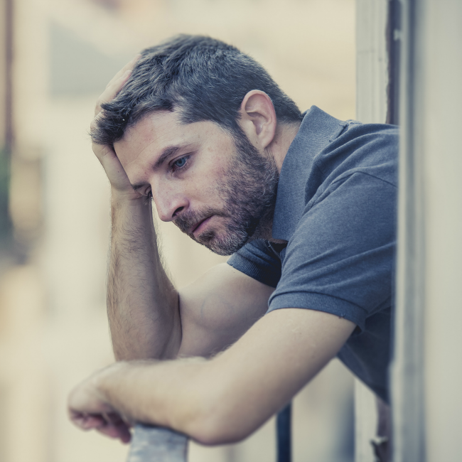 man thinking on balcony