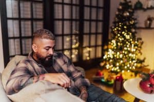 Man sitting on the sofa alone on Christmas Day at home