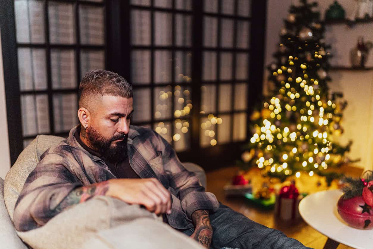 Man sitting on the sofa alone on Christmas Day at home