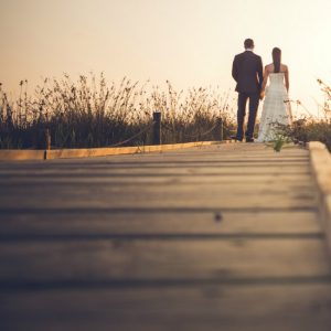 newlywed couple on wooden bridge