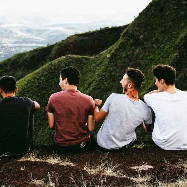 4 guys laughing outside by mountain