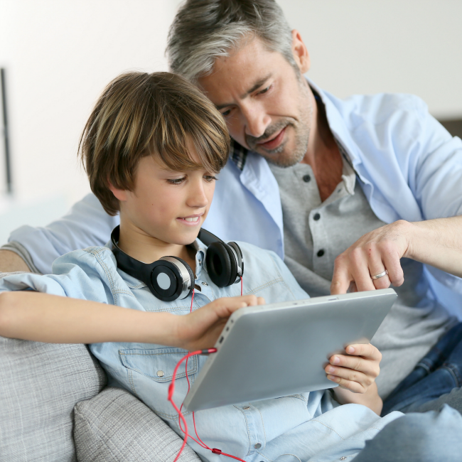 dad talking to son about tablet