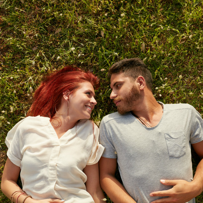 couple smiling in grass